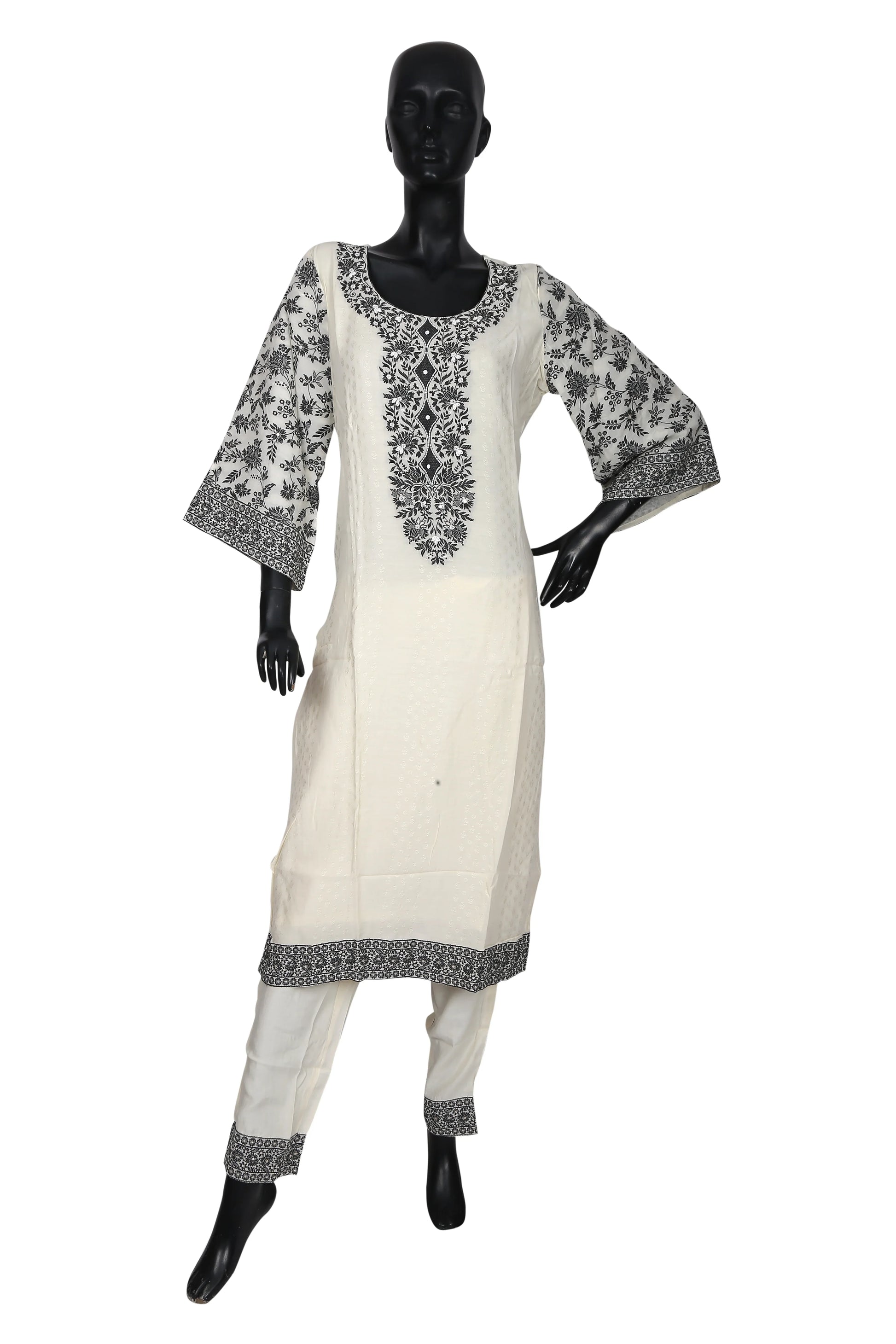 White kurta pajama with black floral embroidery on mannequin, traditional ethnic wear
