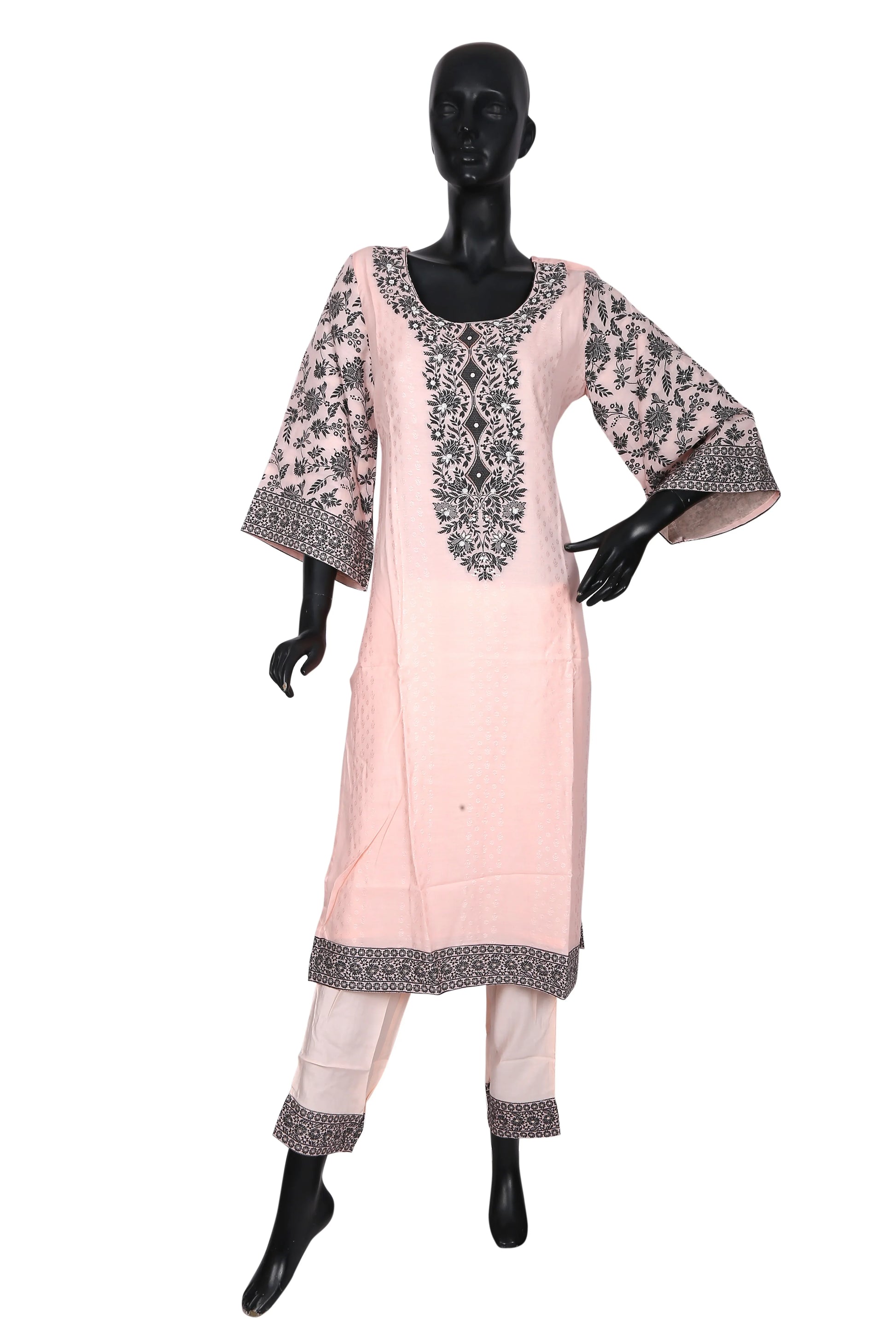 Mannequin wearing light pink kurta set with black floral embroidery and matching pants