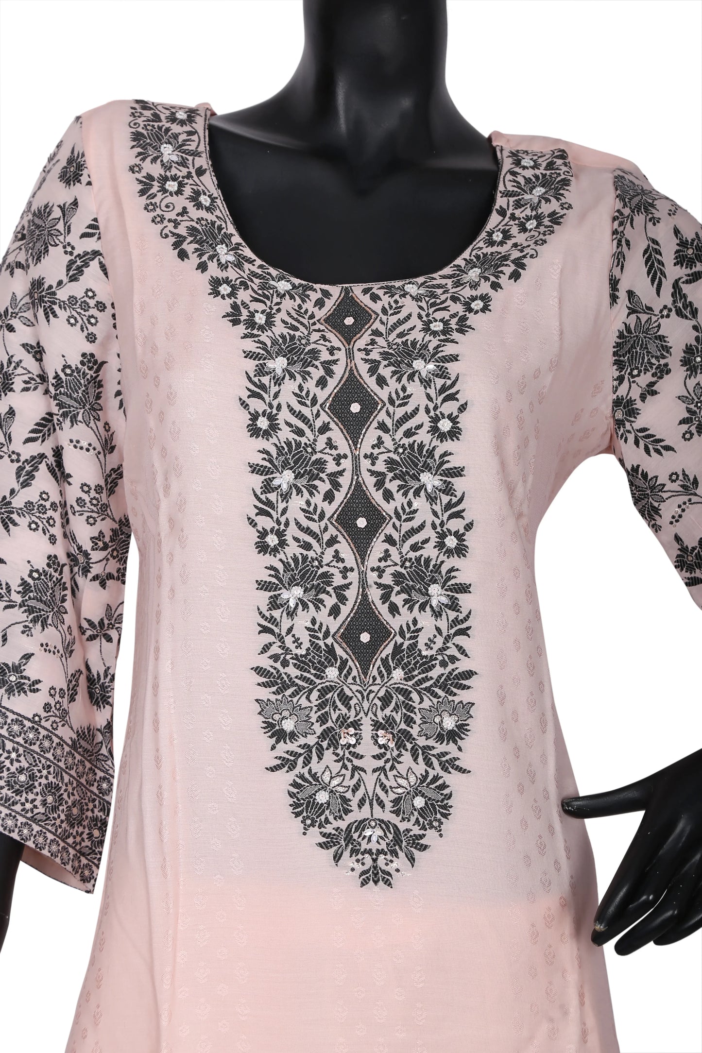 Light pink kurti with black floral embroidery on front and sleeves, displayed on mannequin