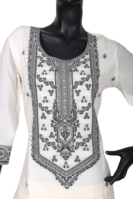 White cotton kurti with intricate black embroidery on front, displayed on mannequin