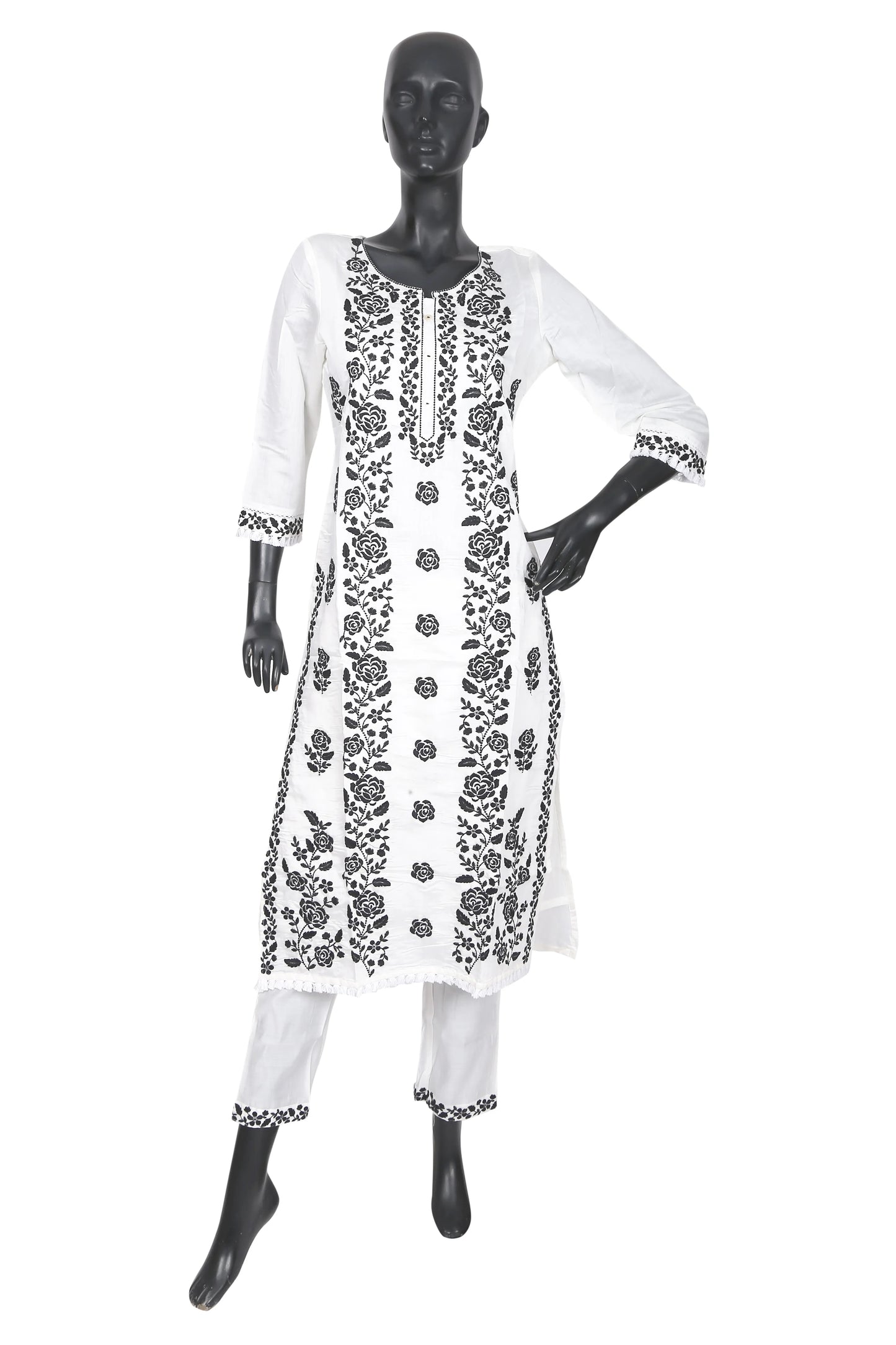 White kurta set with black floral embroidery displayed on mannequin
