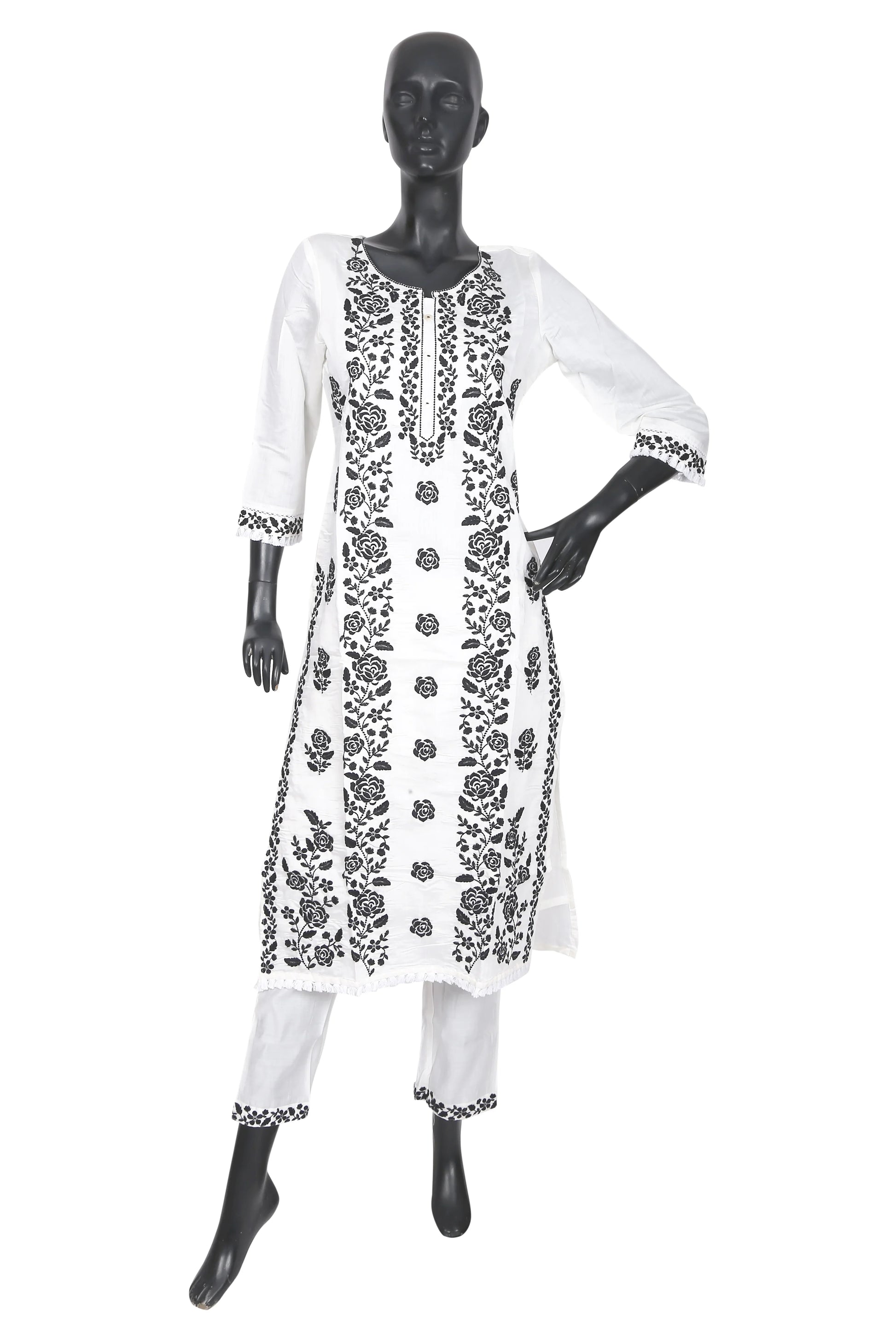White kurta set with black floral embroidery displayed on mannequin